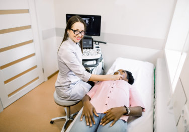 female doctor doing sonography to a patient