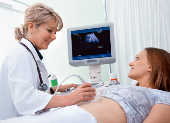 Pregnant woman getting ultrasound