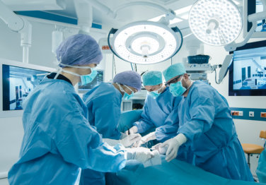 group of surgical doctors doing surgery in an operating room