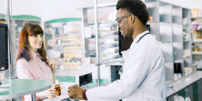 male pharmacist and lady customer talking