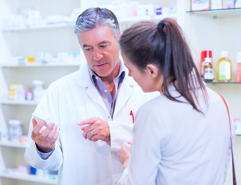 male pharmacist and a lady talking